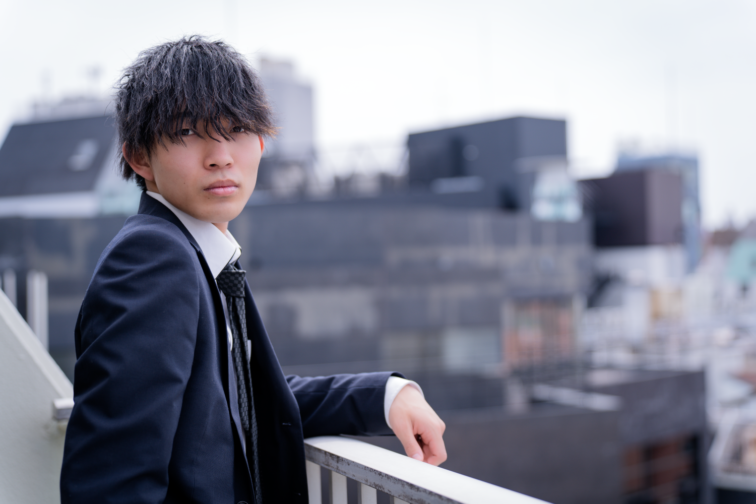 Business portrait of a Japanese man on the balcony of JG studio.