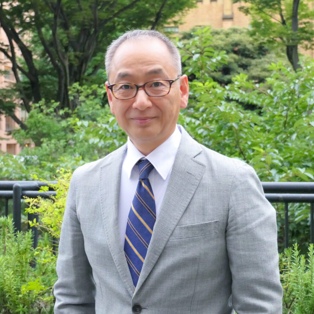 Outdoor headshot of a company executive