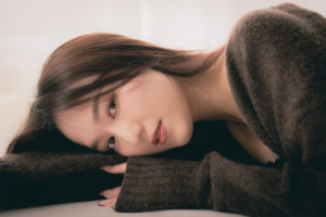 Natural light studio portrait of a woman lying on the floor