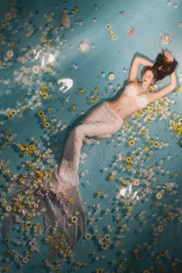 Aiko, a versatile model in Tokyo, dressed as a mermaid in a creative underwater photoshoot with flowers.