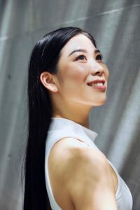 Kanna, a professional fitness model in Tokyo, posing gracefully in a sleeveless top.