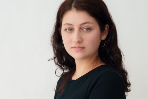 Professional Headshot Professional headshot of a woman with long hair, wearing a black top.