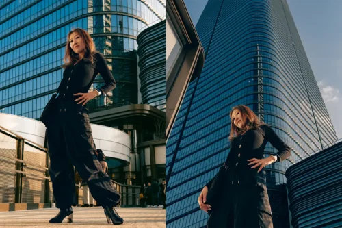 Urban Portraits in Tokyo Woman posing in a black outfit in front of a modern skyscraper in Tokyo.