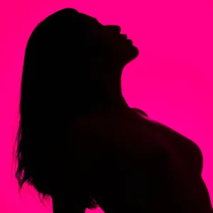 Portrait Silhouette at Tokyo Photo Studio Silhouette of a model in artistic portrait session at Tokyo photo studio, vibrant pink background.