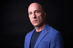 Professional portrait of British author Andrew Rankin, posed in a blue blazer for his next book cover.