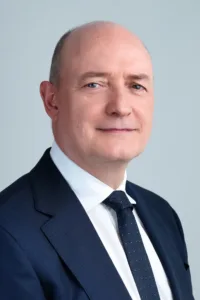 Professional headshot of a man in a dark suit by JG Studio.