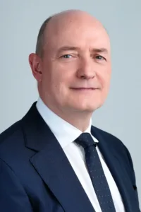 Professional headshot of a man in a dark suit by JG Studio.