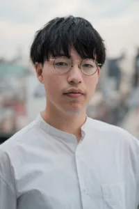 Professional portrait of a young man wearing glasses in Tokyo, ideal for corporate headshots and personal branding by JG Studio.